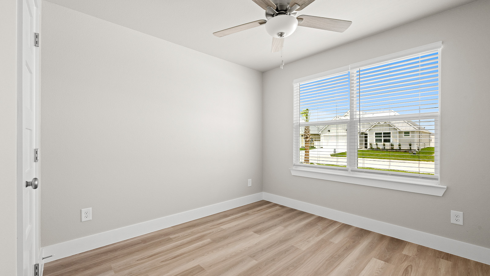 Bedroom 2 in front of home with large divided light window
