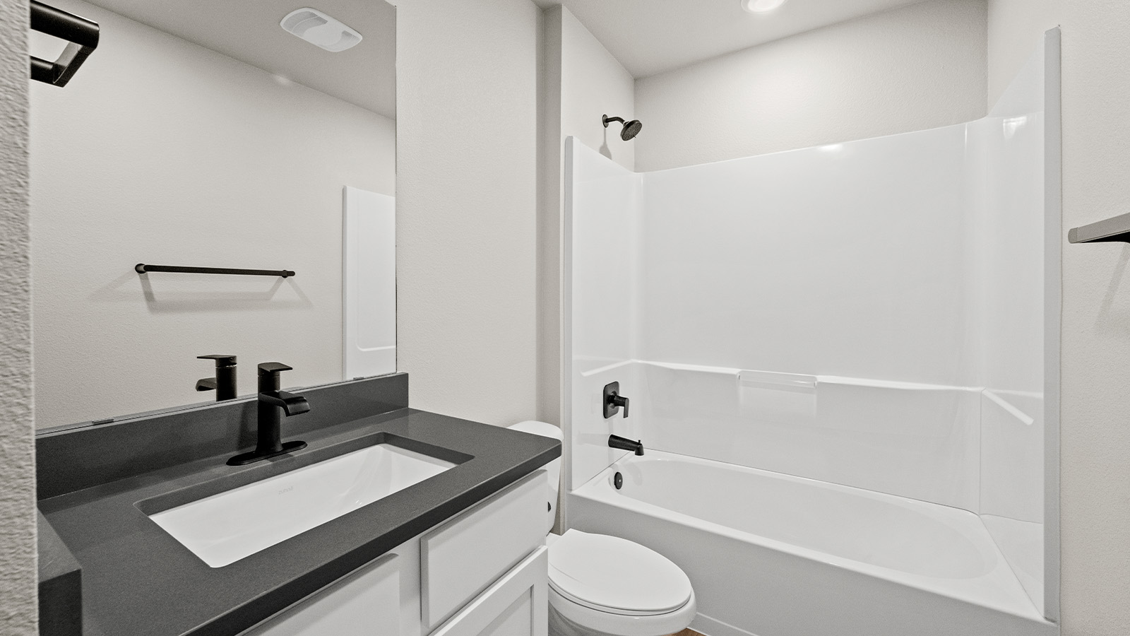 Second bathroom with quartz counters and tub and shower combo