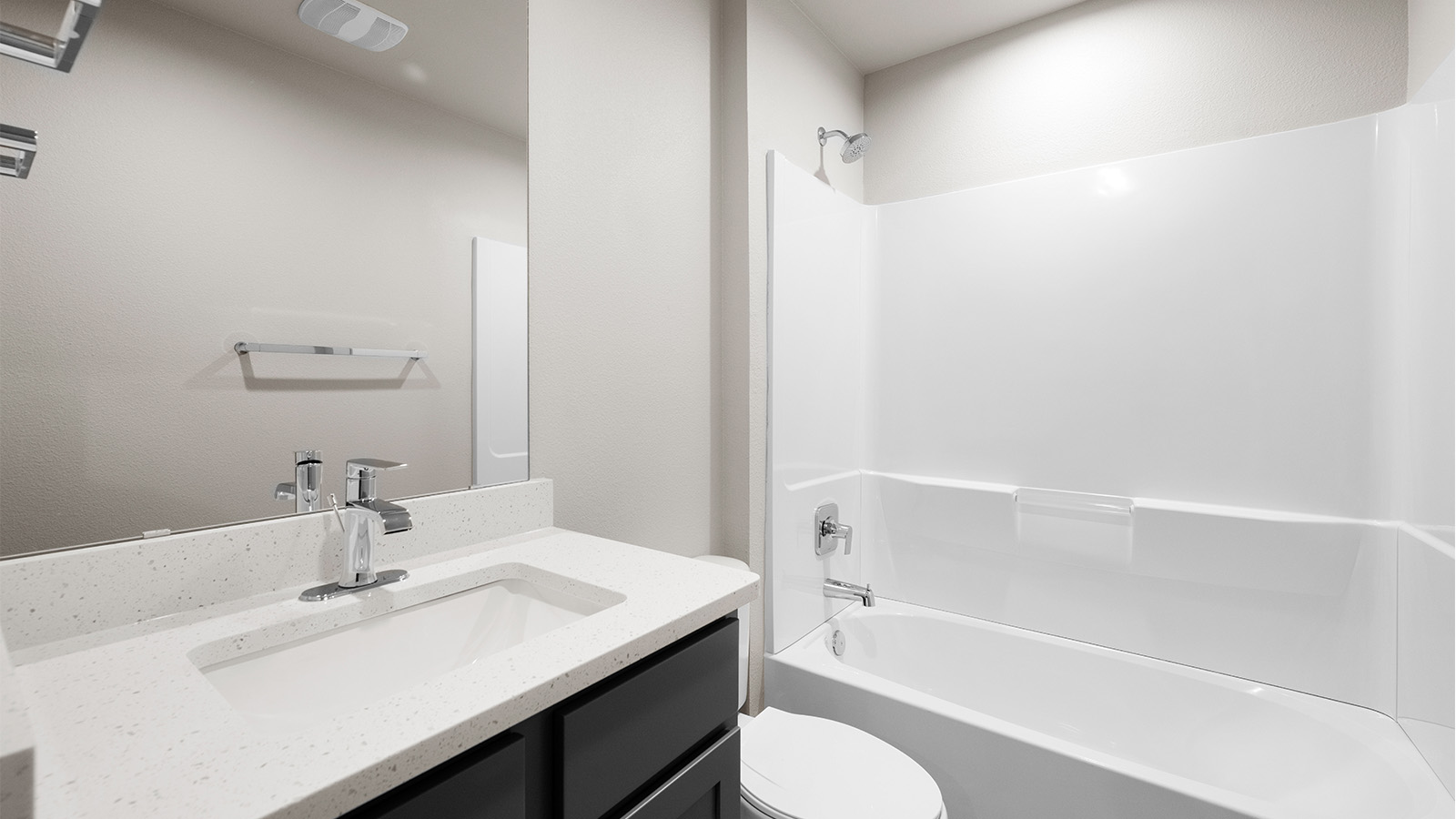 second bath with tub shower combo quartz counters and under sink storage