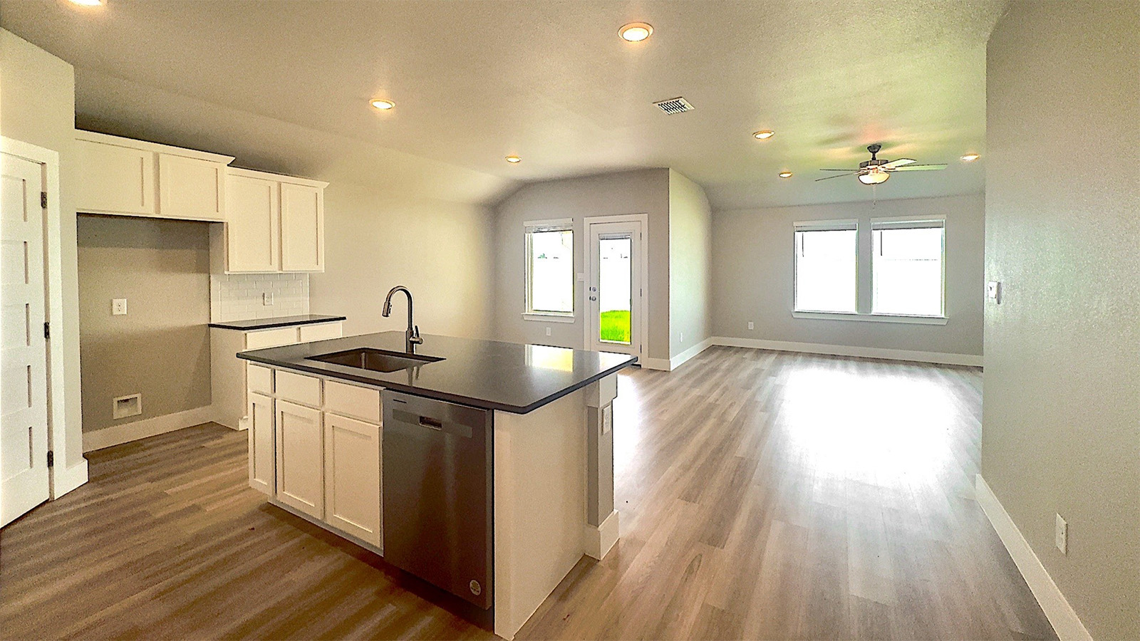 Open concept living dining and kitchen Lighthouse EVP flooring