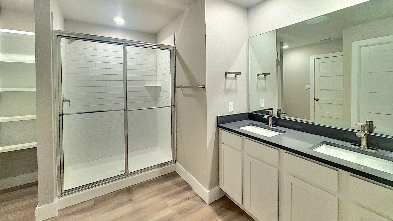 Primary bathroom with walk in shower and quarts counters
