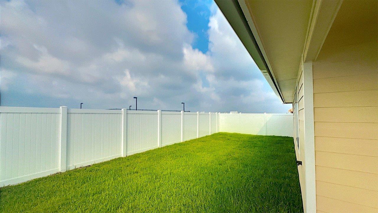 Back yard with full vinyl fencing