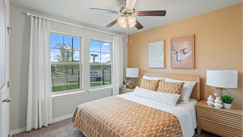 Bedroom three with carpeted floors and two large double windows for natural light.