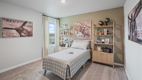 Bedroom two with carpeted floors and large single window for natural light.