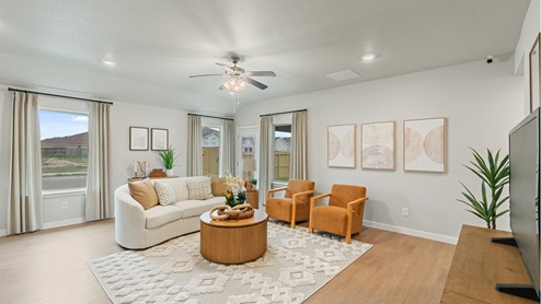 Spacious living area with three large windows for natural lighting.