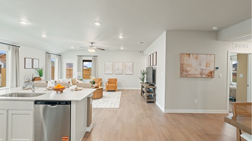 Open concept kitchen with large island with view of the living and and dining area.