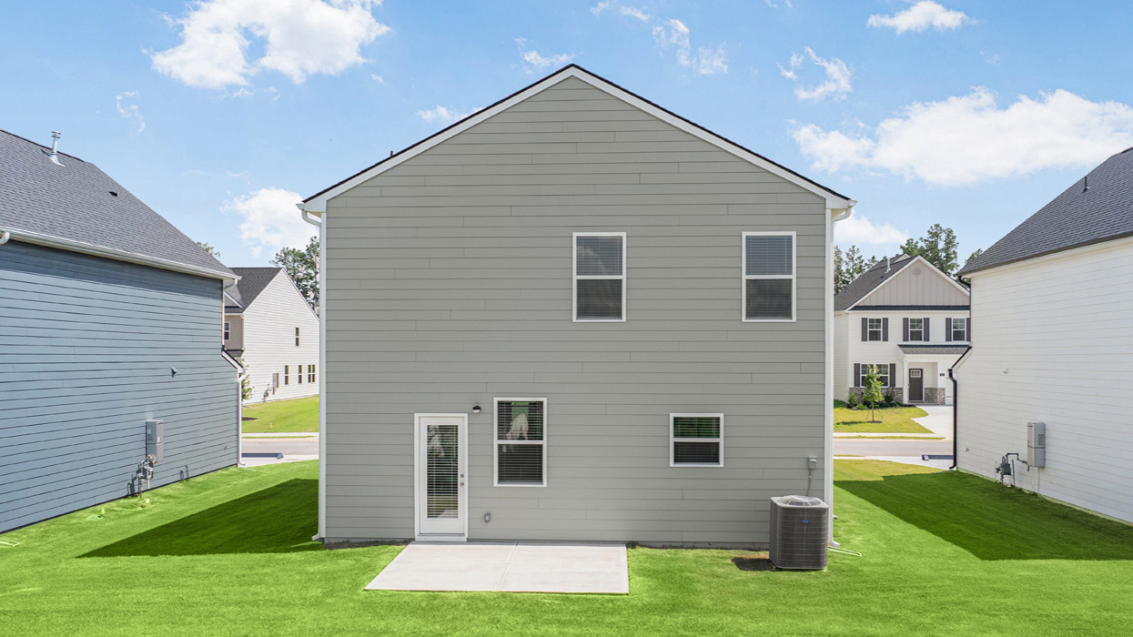 Rear of two story home with back patio