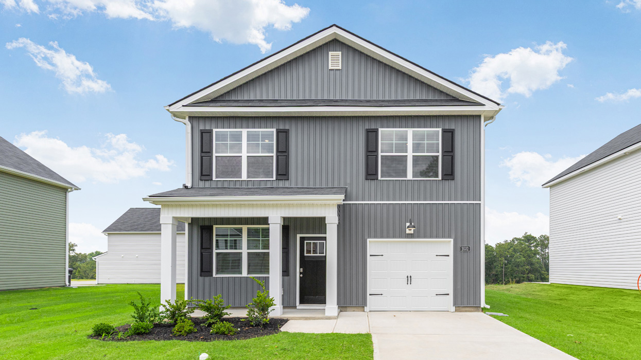 Two story home with covered porch and one-car garage