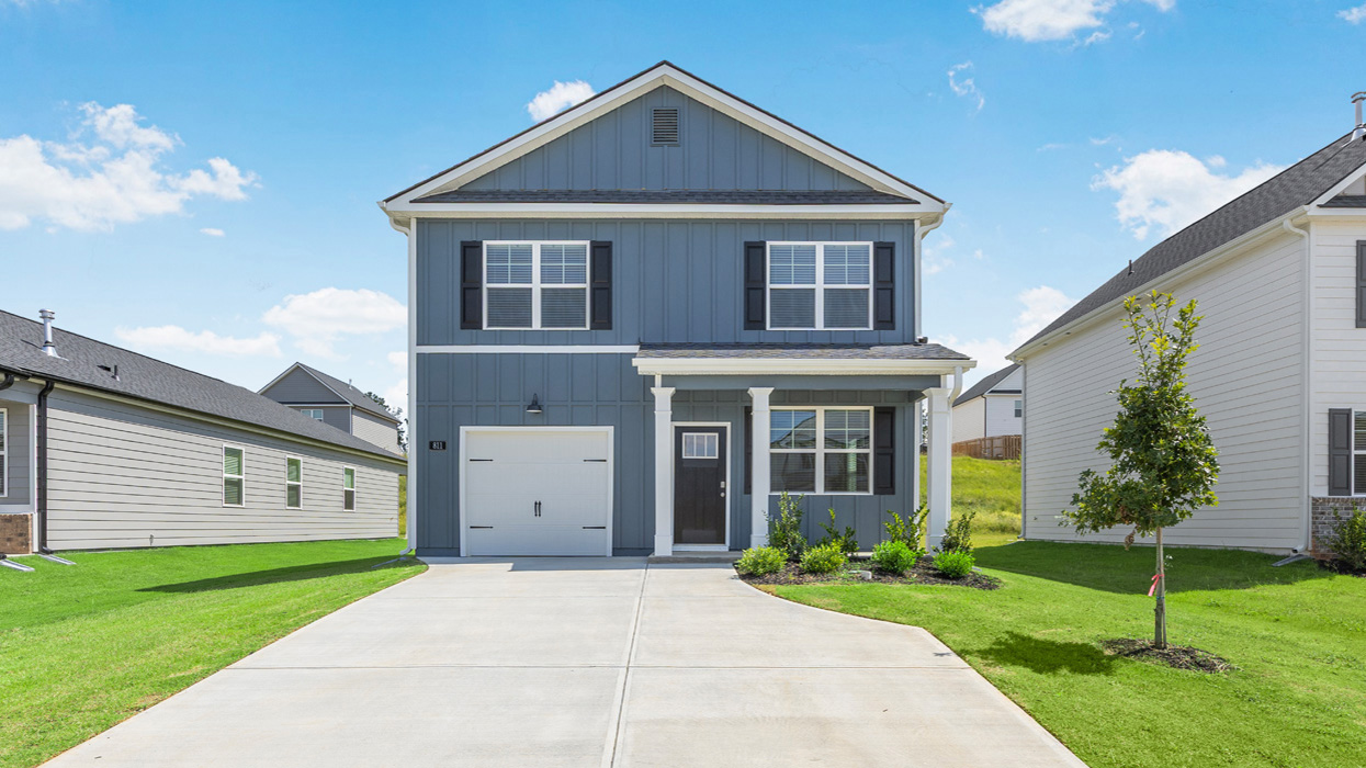 Two story home with covered porch and one-car garage