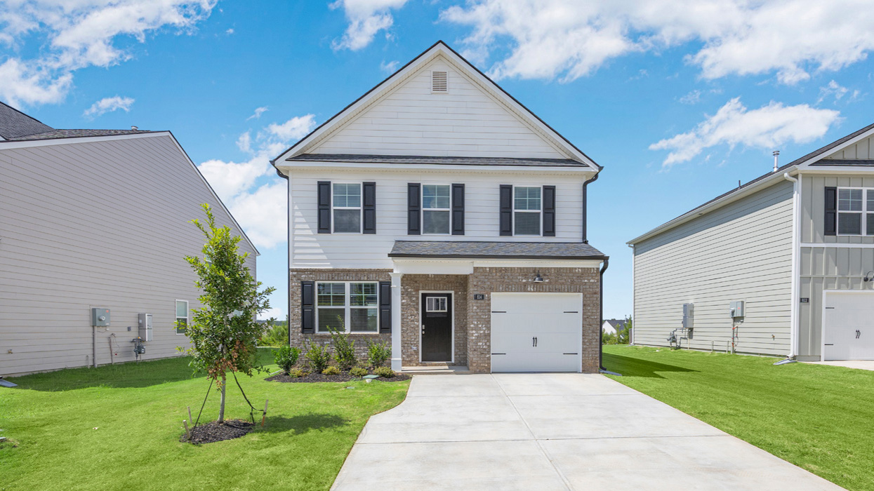 Two story home with brick trim and one-car garage