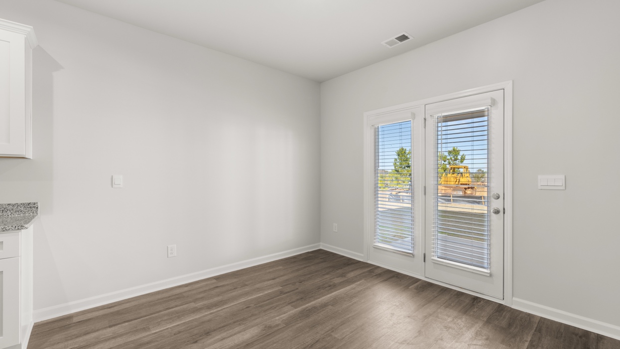 Dining area off of kitchen with sightlines to back door.