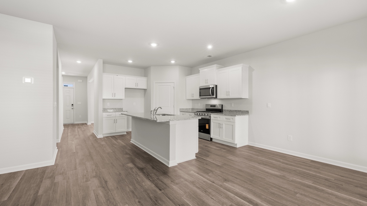Open dining and kitchen area with sightlines to front door.