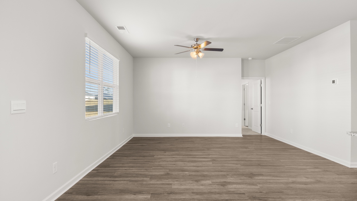 living room with ceiling fan and natural light