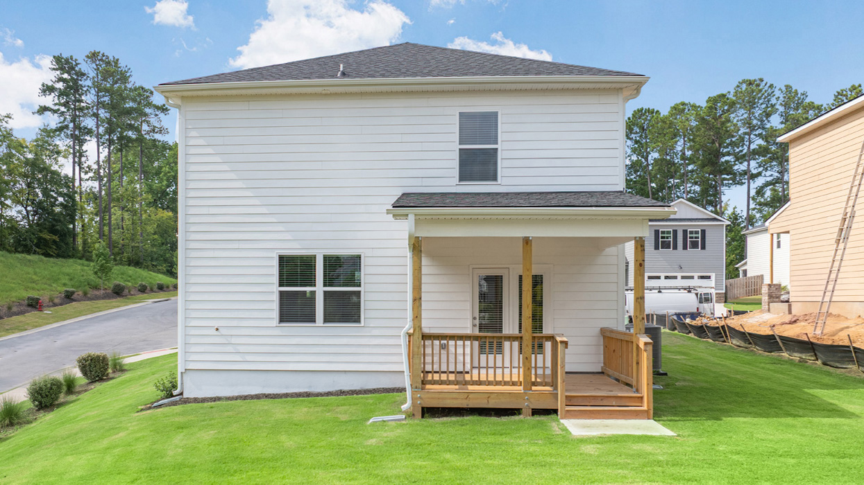 Rear of two story home with covered back deck