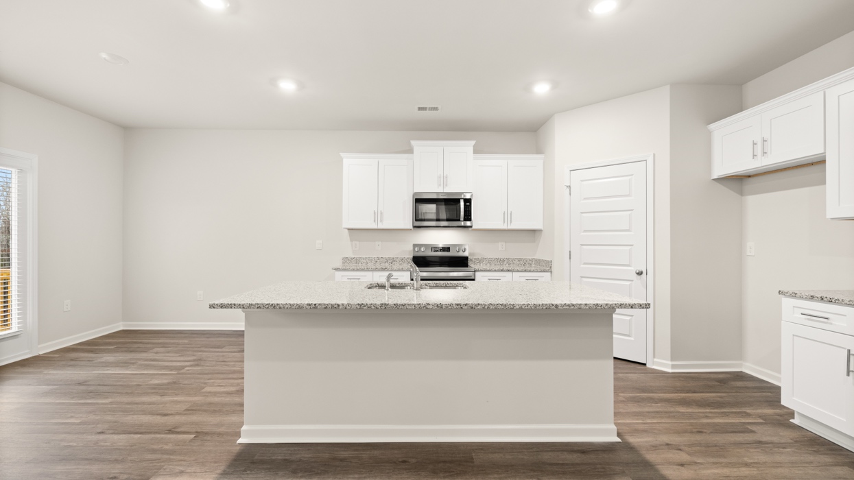 kitchen with large center island and spacious white cabinetry