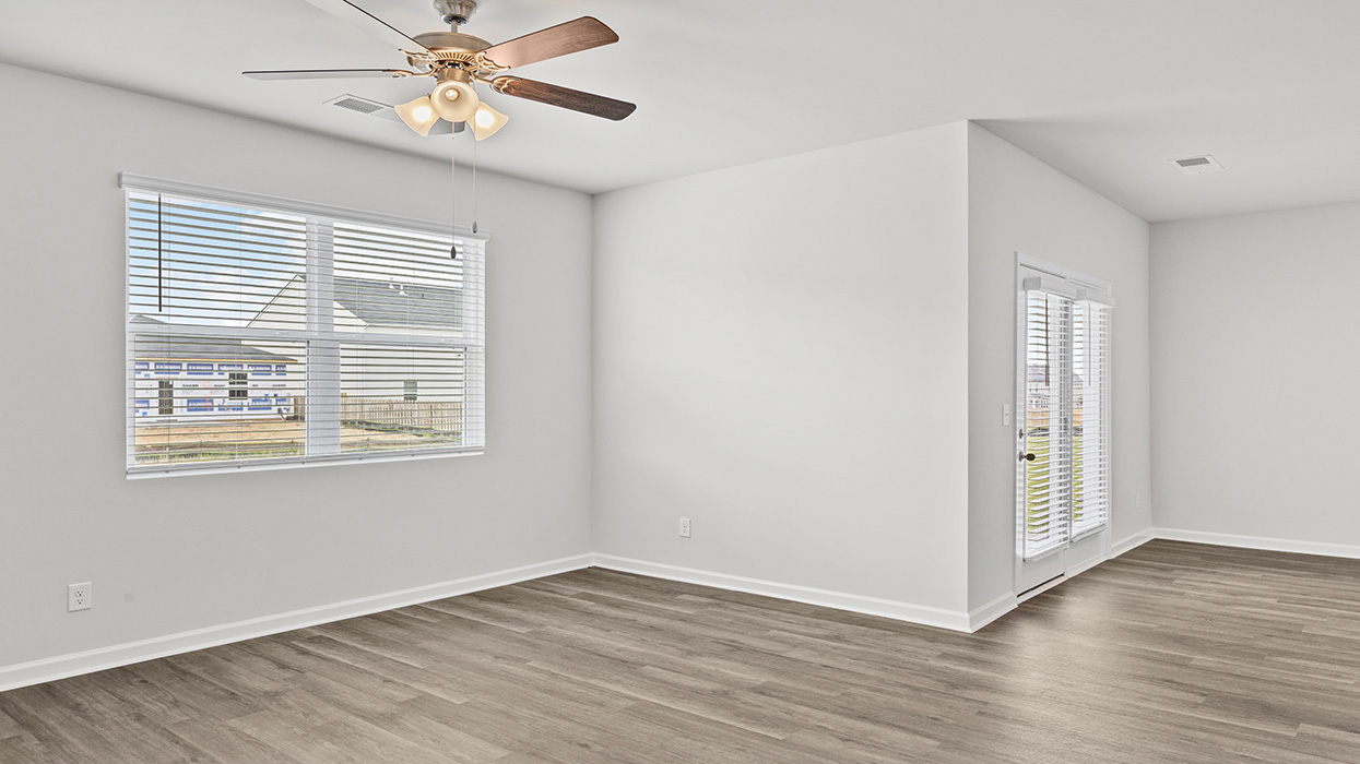 Open floorplan featuring an expansive living room/dining room with back door to covered porch.