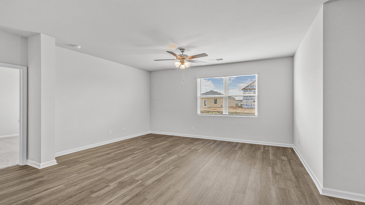 Open floorplan featuring an expansive living room/dining room with back door to covered porch.