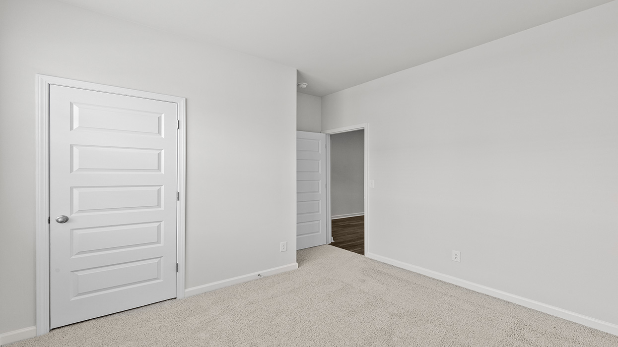 Guest bedroom with carpeting and flush mount light fixture