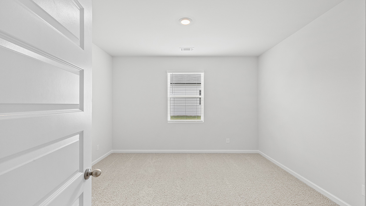 Guest bedroom with carpeting and flush mount light fixture
