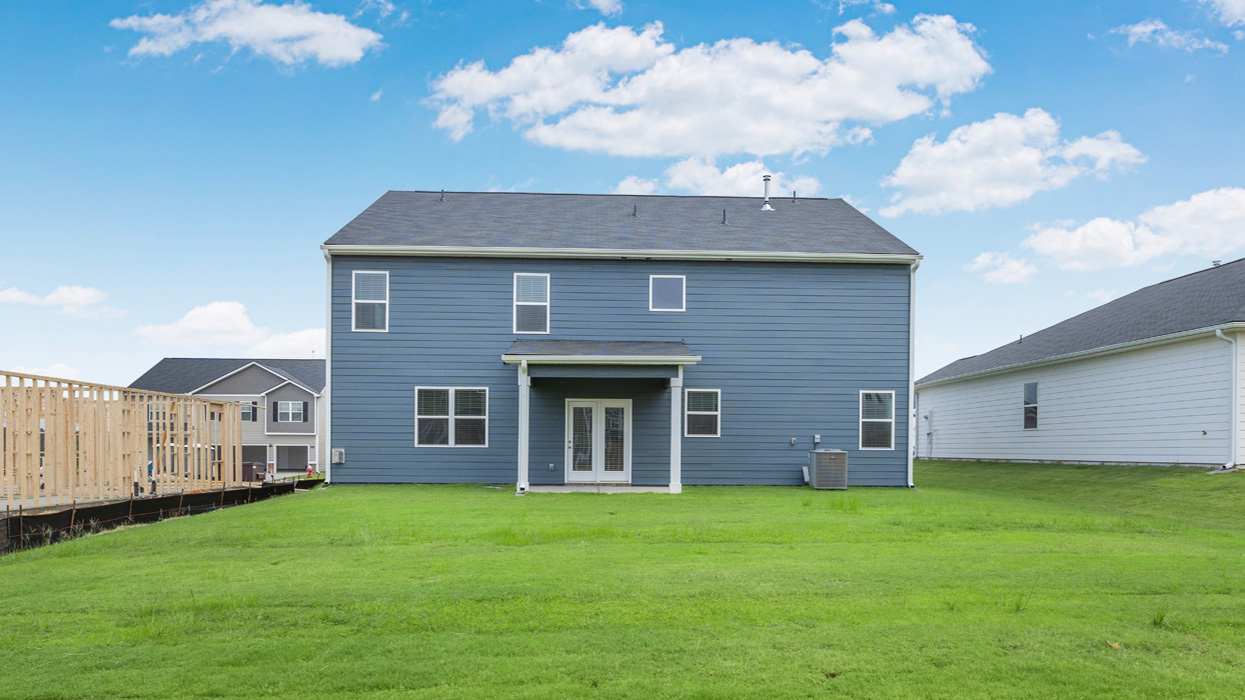 Rear of two story home with covered back patio