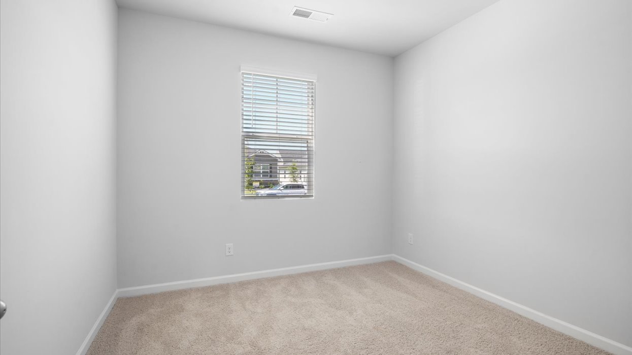 Guest bedroom with carpeting and flush mount light