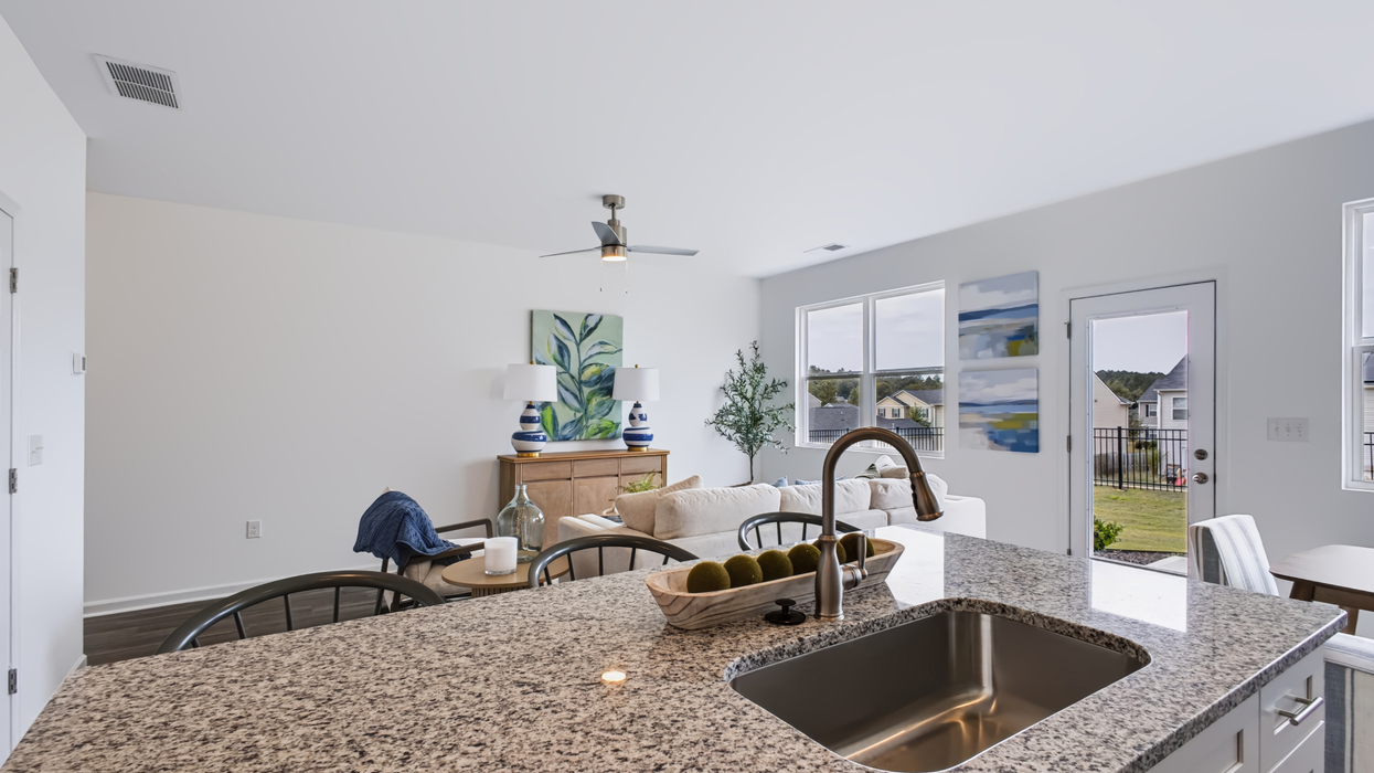 Open plan with modern kitchen overlooking the living and dining area