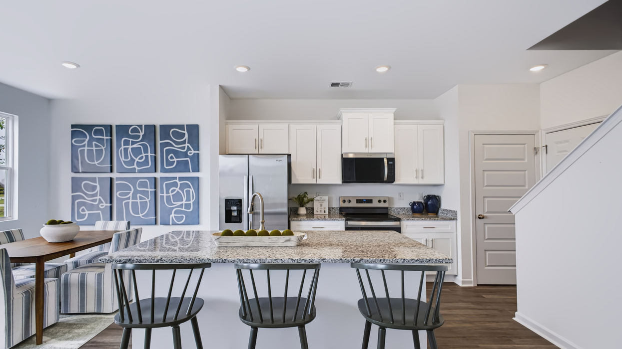 Open plan with modern kitchen overlooking the living and dining area