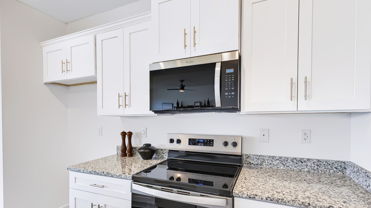 Modern kitchen Open plan with modern kitchen overlooking the living and dining areawith grey shaker cabinets overlooking dining and living area.
