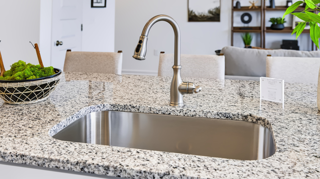 Modern kitchen Open plan with modern kitchen overlooking the living and dining areawith grey shaker cabinets overlooking dining and living area.
