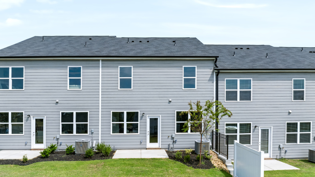 Rear of two story townhome with patio