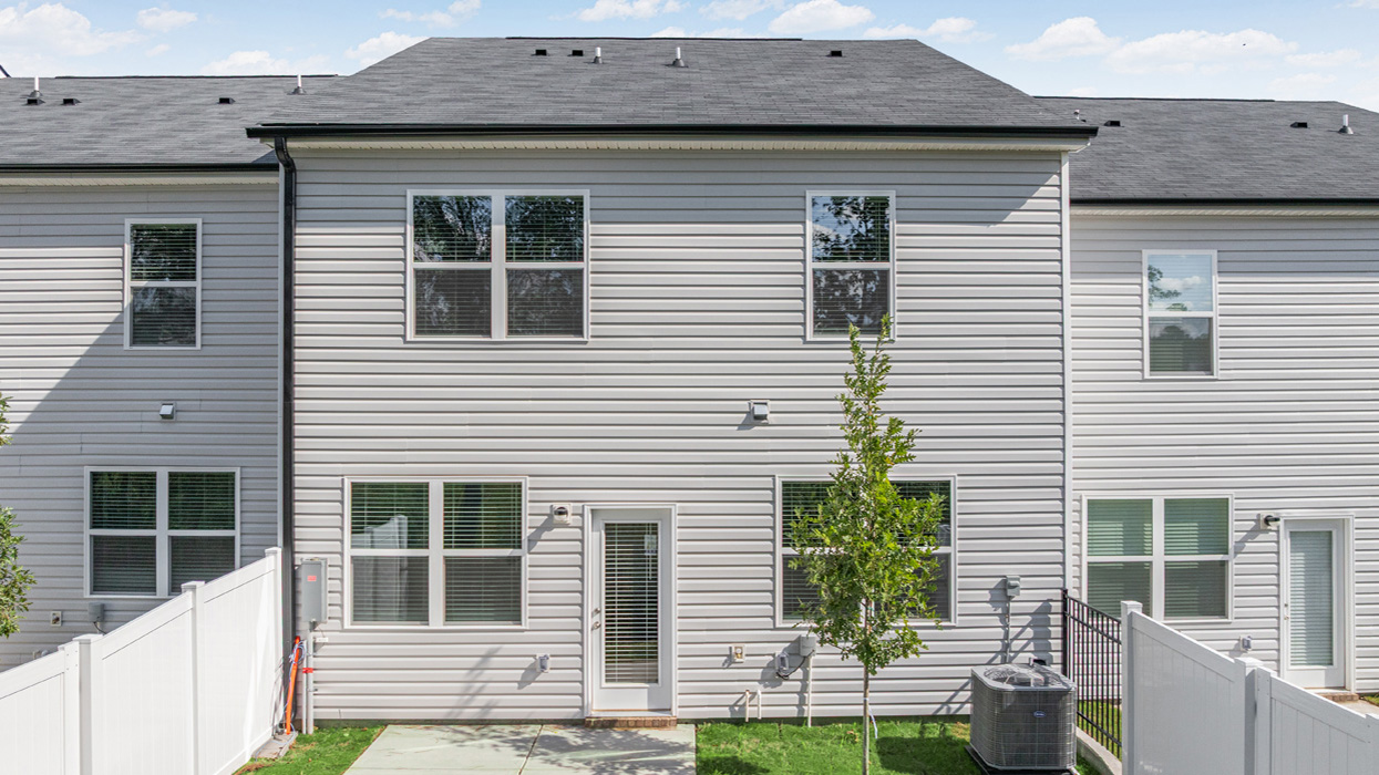 rear of Two story townhome with a two-car garage