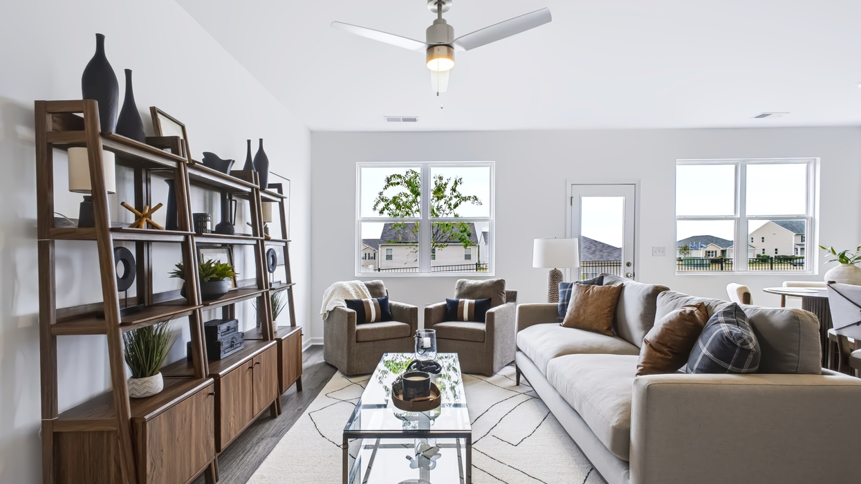 open concept plan with living and dining room overlooking modern kitchen