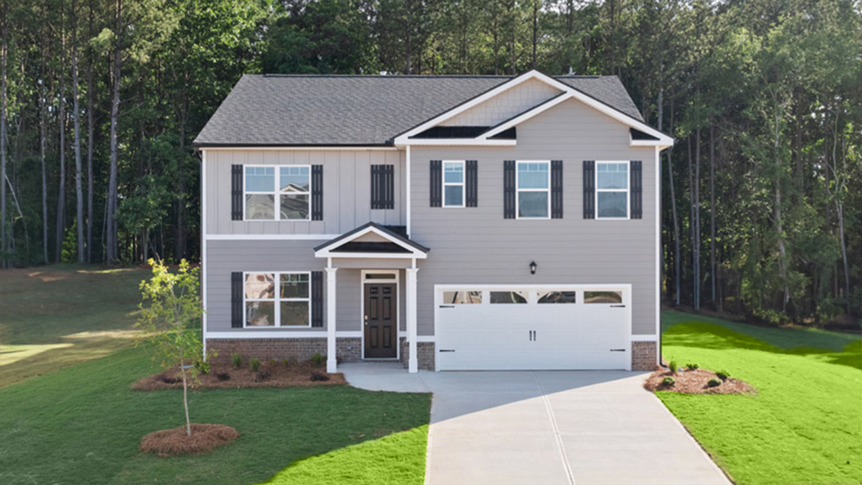 Two story home in beige with two car garage