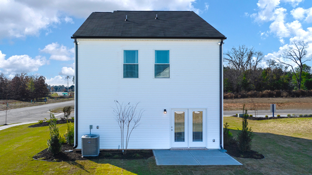 Rear of two story home with back patio