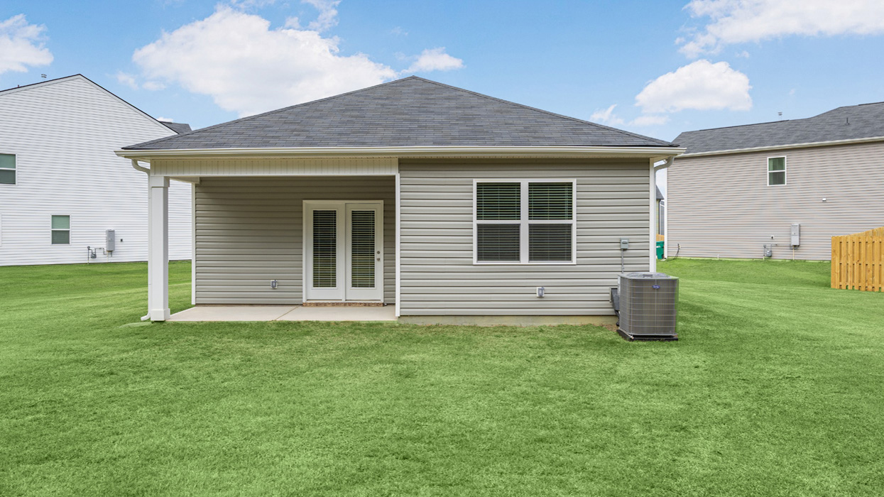 Rear of single story ranch home with two car garage