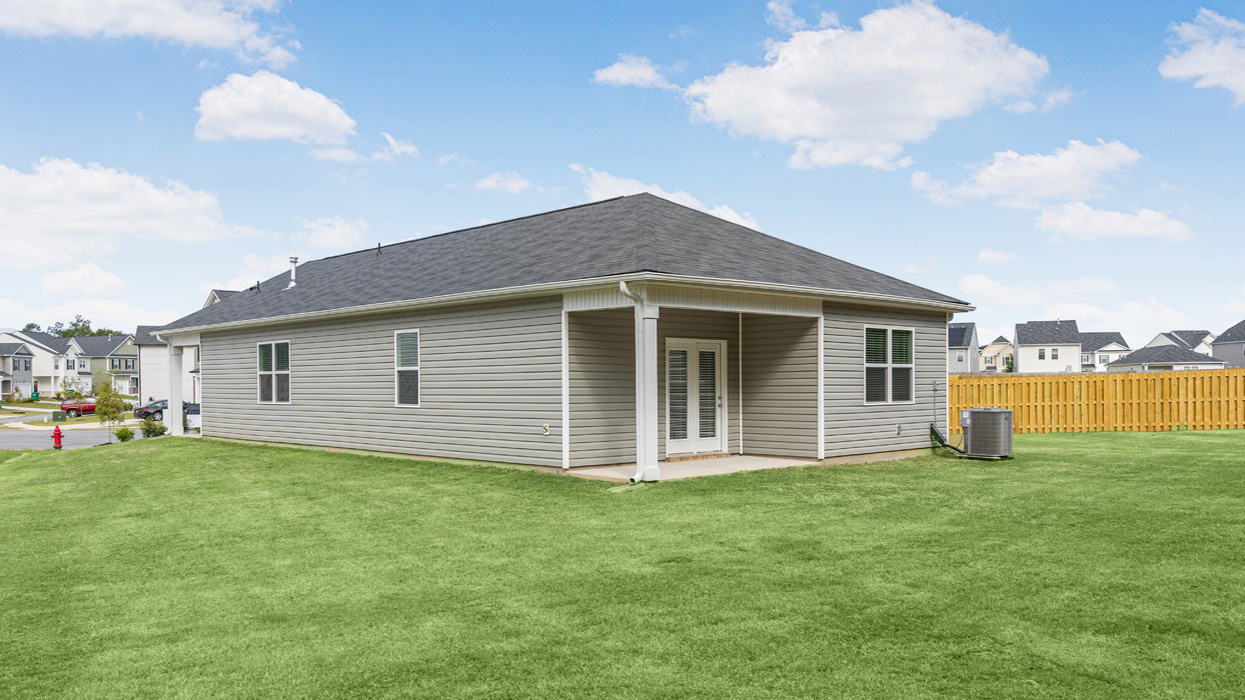 Rear of single story ranch home with two car garage