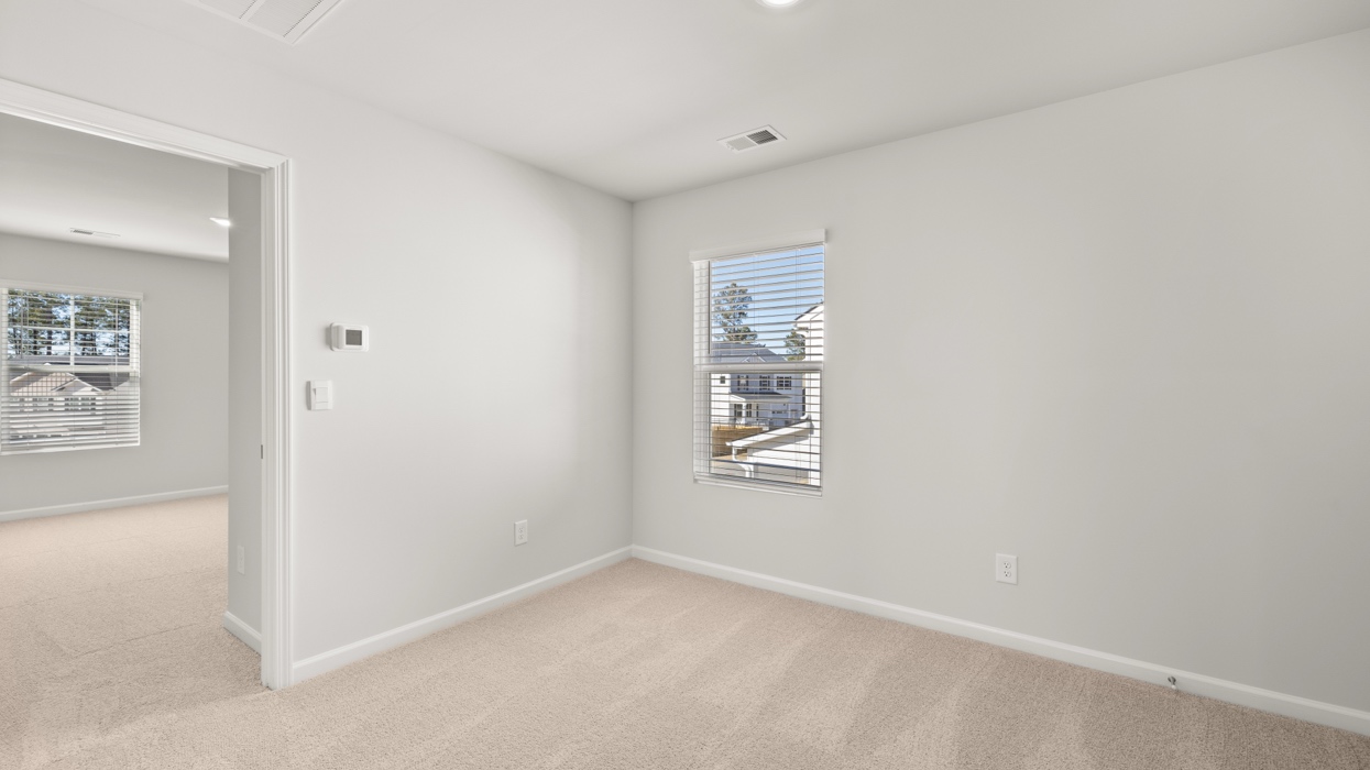Loft area at top of staircase landing with sightlines to bedrooms