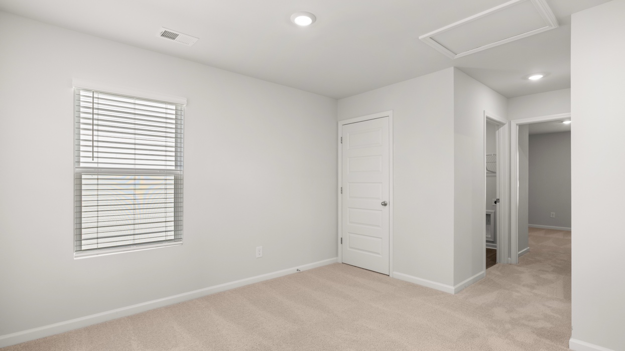 Loft area at top of staircase landing with sightlines to bedrooms