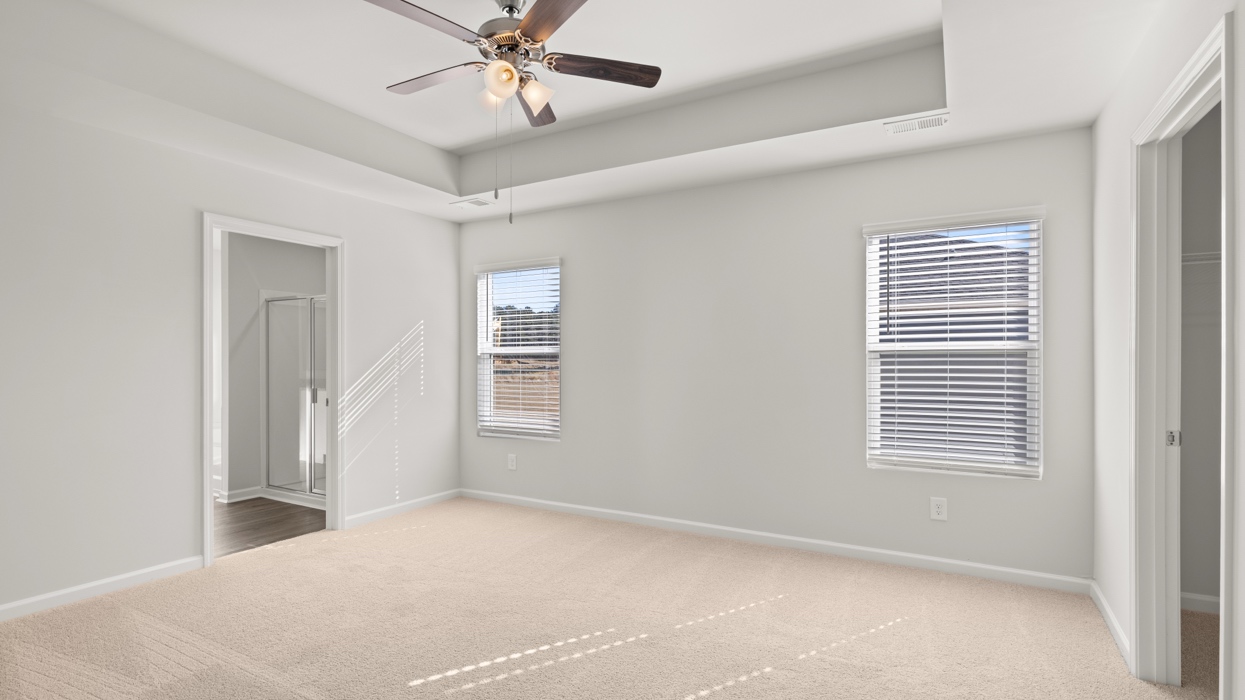 Primary bedroom with tray ceilings, en suite bath, and huge primary closet.