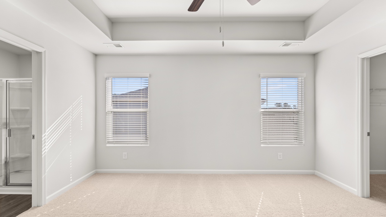 Primary bedroom with tray ceilings, en suite bath, and huge primary closet.