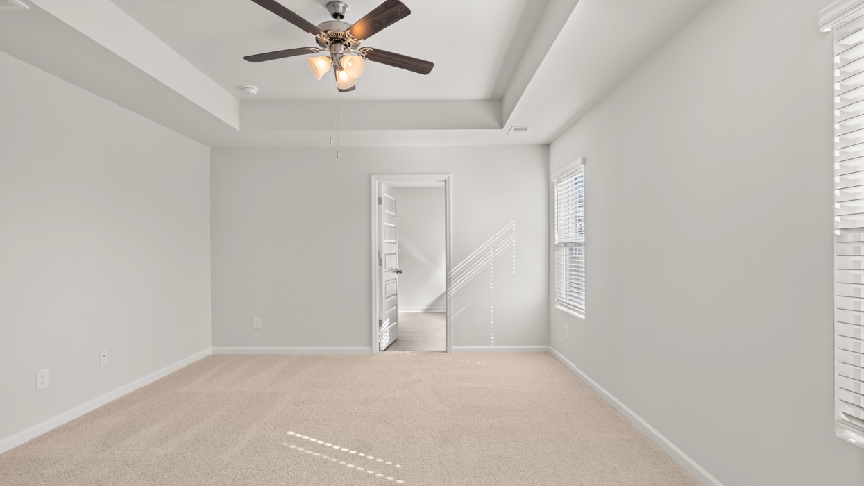 Primary bedroom with tray ceilings, en suite bath, and huge primary closet.