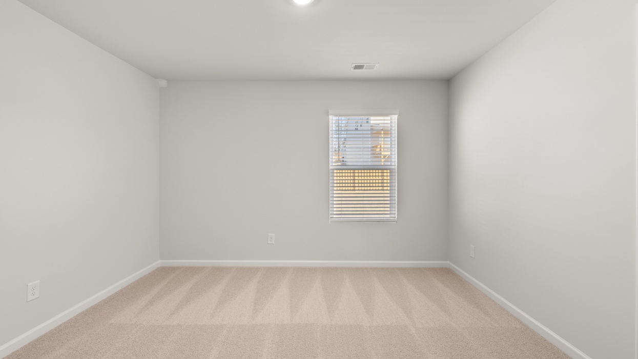 Guest bedroom upstairs with carpeting and closet.