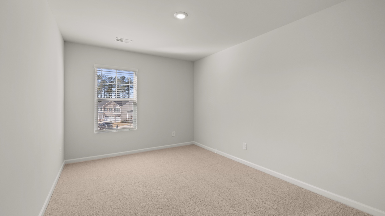 Guest bedroom upstairs with carpeting and closet.