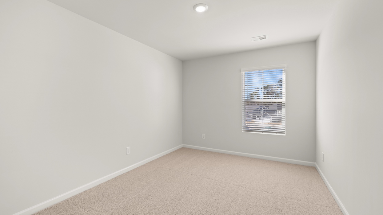 Guest bedroom upstairs with carpeting and closet.