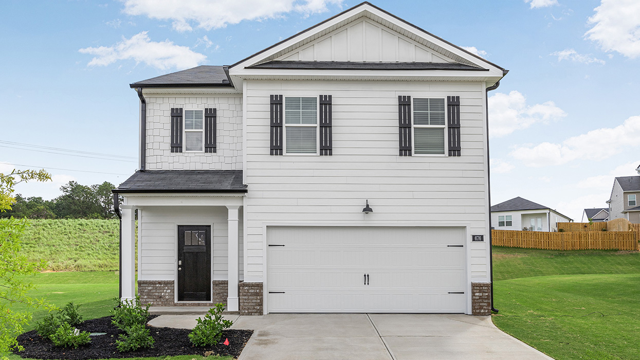 Two story white home with two car garage