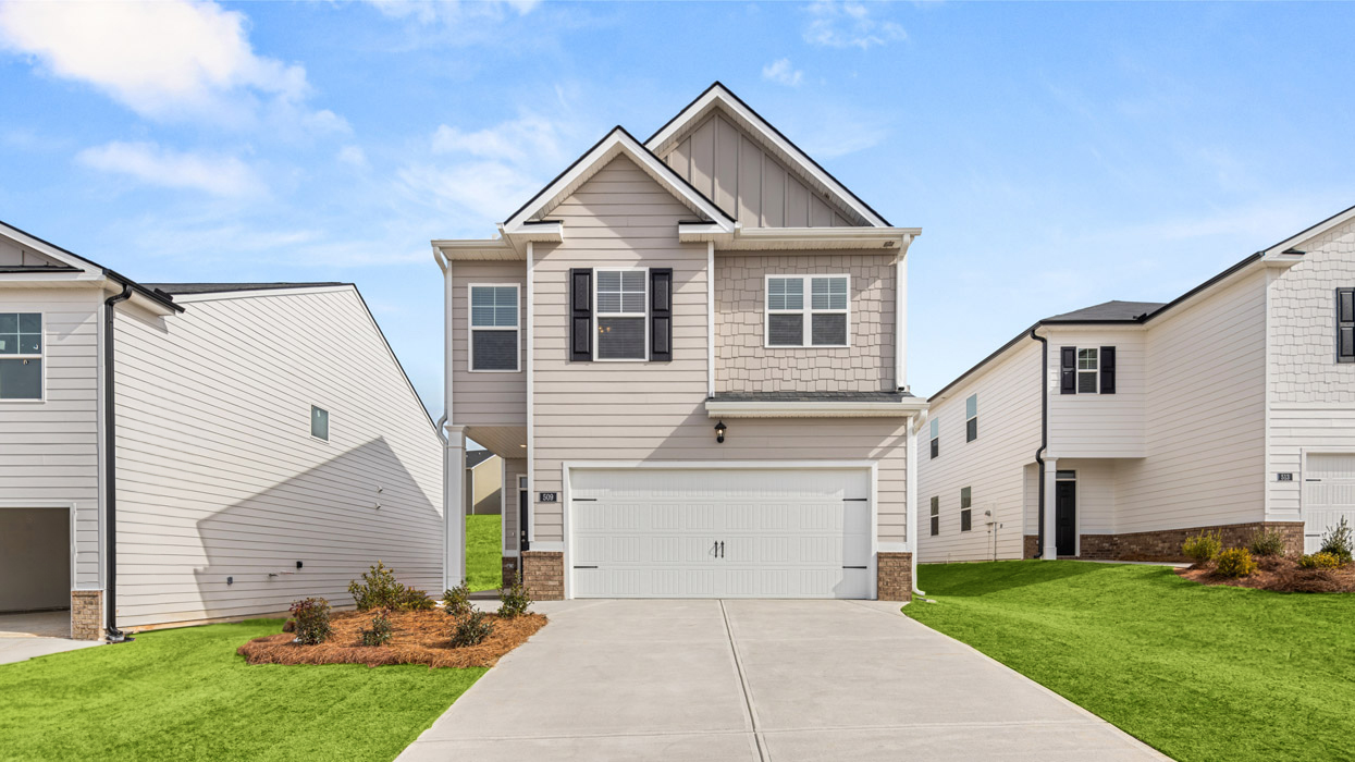 Two story home in beige with two car garage