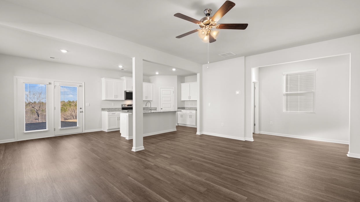 Open plan with living, dining, and kitchen in the heart of the home.