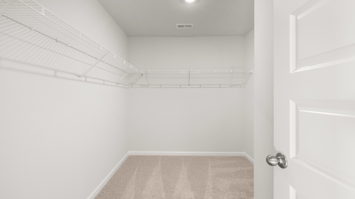 Large closet in primary bedroom with shelving