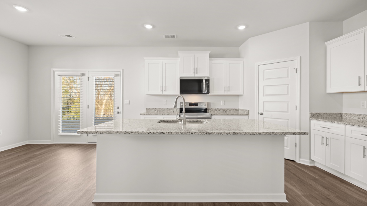 Open plan featuring large living and dining area opening to kitchen with large center island.