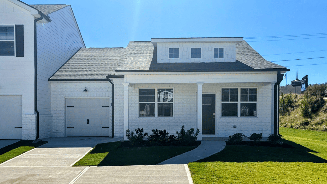 Single story white townhome with covered front porch